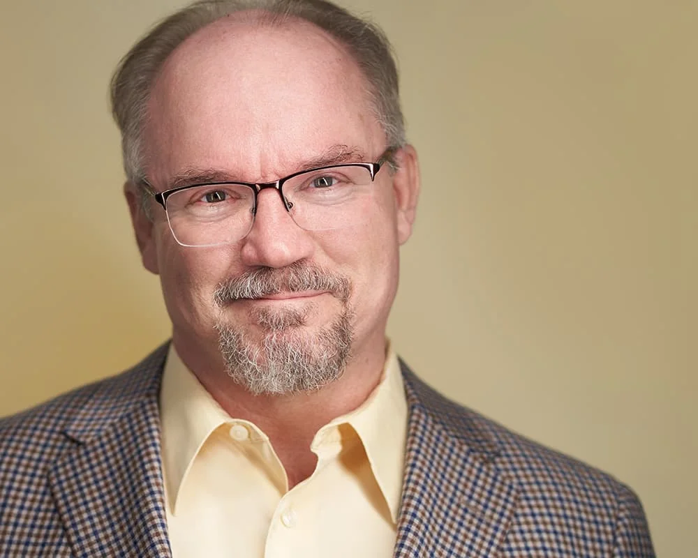 University professor on yellow background