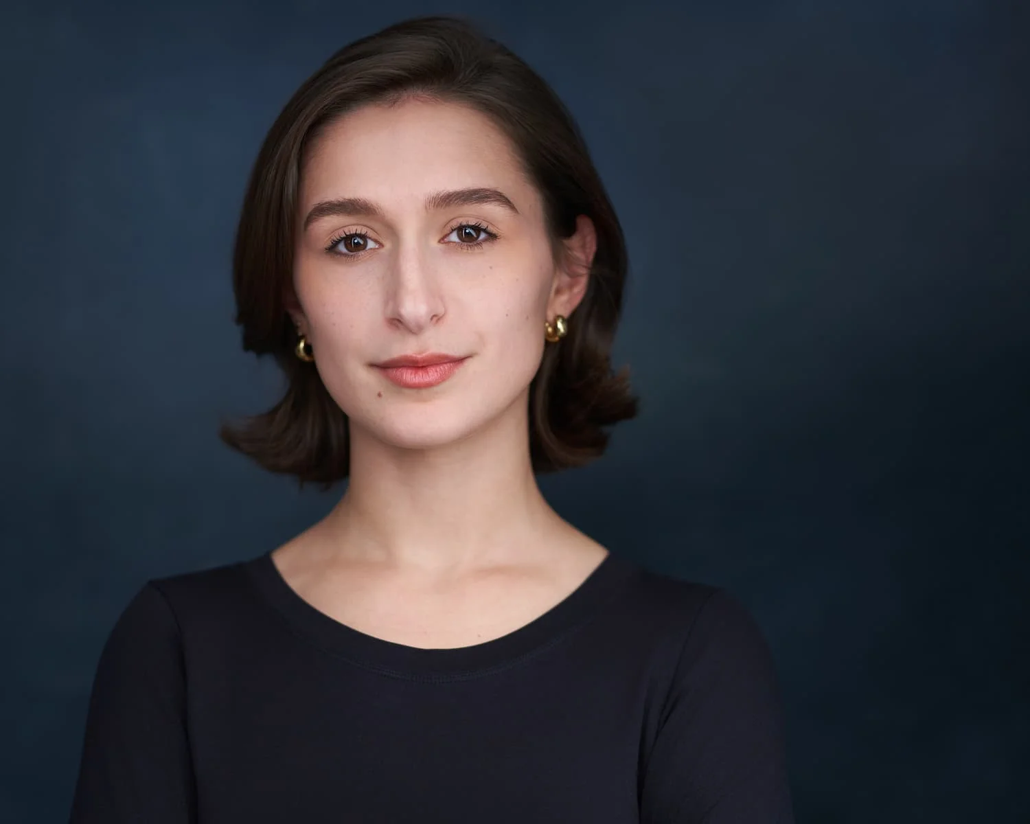 Professional headshot with dark background