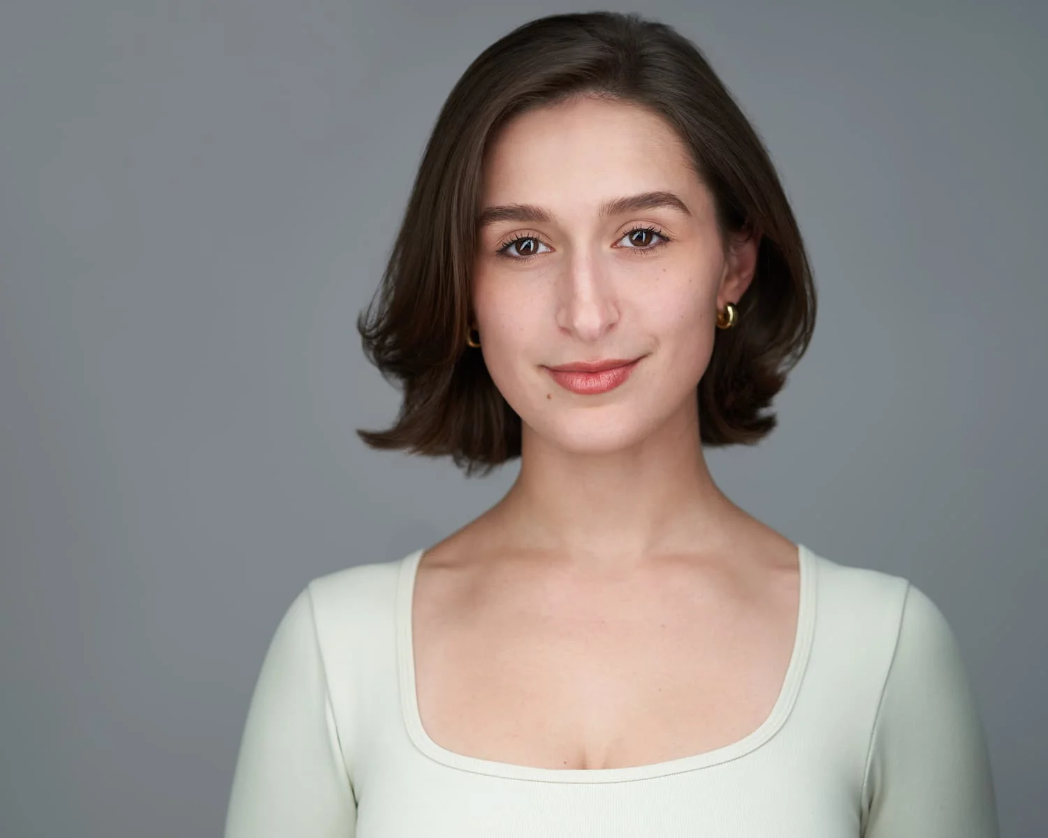 Professional headshot with gray background
