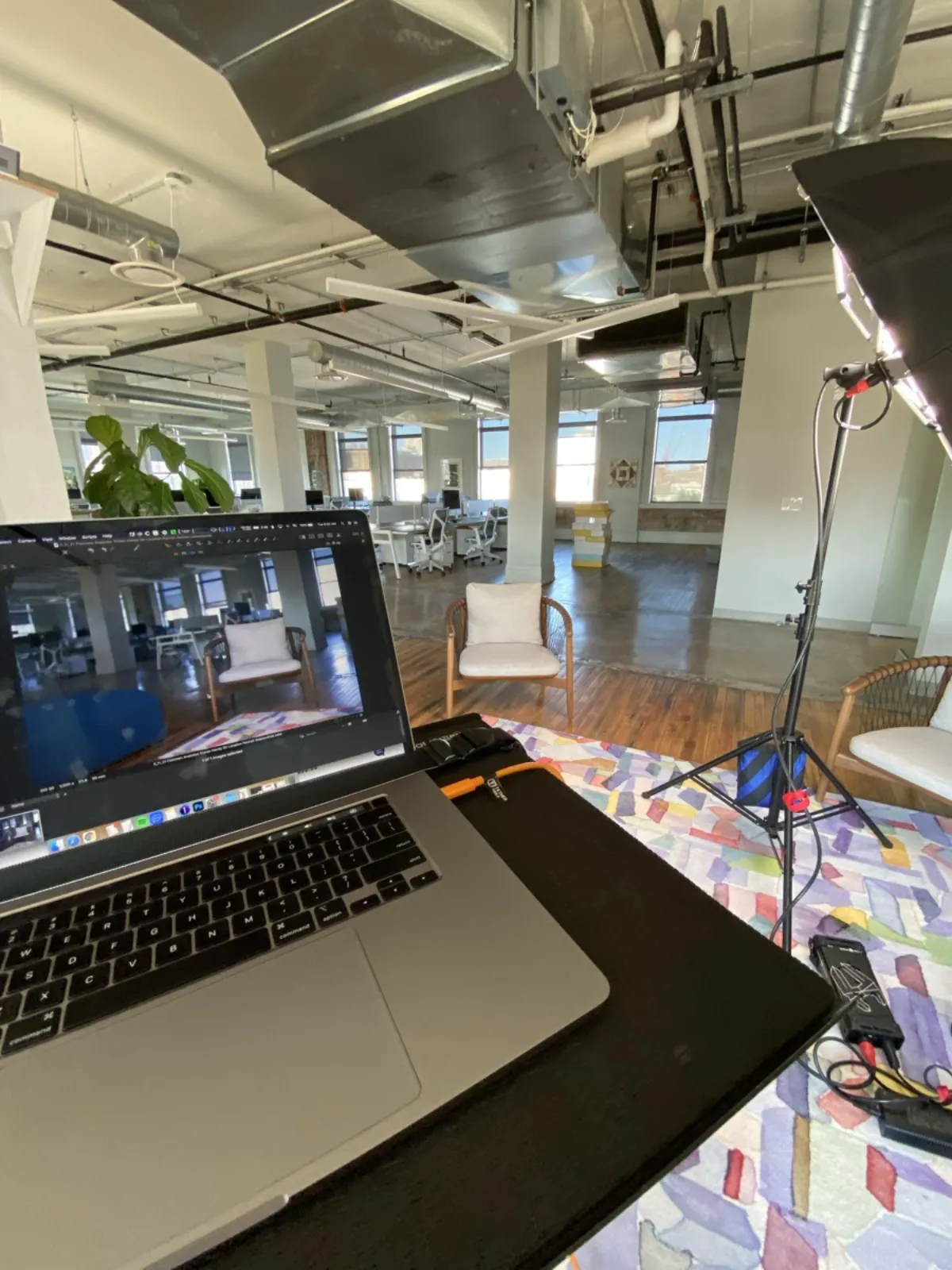 On-location headshot photography setup in an office space with tethered shooting laptop